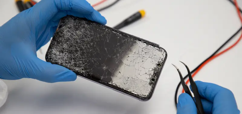 A data recovery engineer repairs an iPhone to restore lost files.